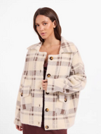 A woman wearing a cream-colored fuzzy plaid coat with brown and gray stripes, featuring large brown buttons, photographed against a solid white background.