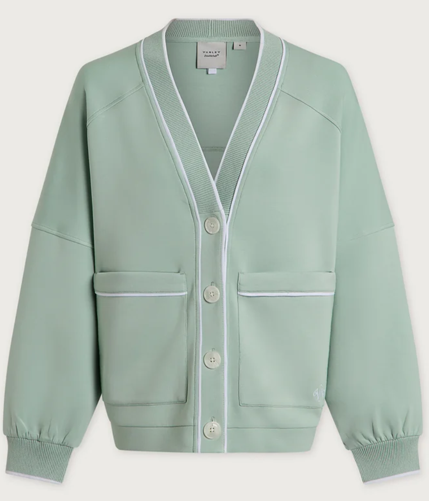 A sage green cardigan sweater with white contrast piping, ribbed trim, and white buttons, shown flat against a light gray background.