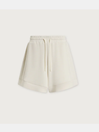 A pair of cream-colored high-waisted shorts with an elastic waistband and a matching drawstring, shown against a solid off-white background.