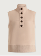 A sleeveless beige vest with a mock neck, featuring a vertical row of five dark brown buttons down the center front and a fringed hem, shown against a light off-white background.